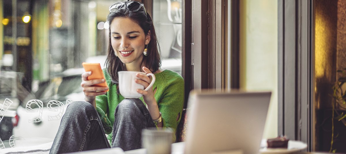 women-having-cup-of-tea-looking-at-phone